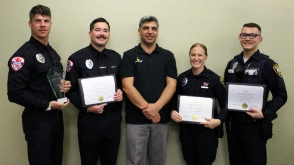 Seref Onder with 4 police officers holding certificates & award